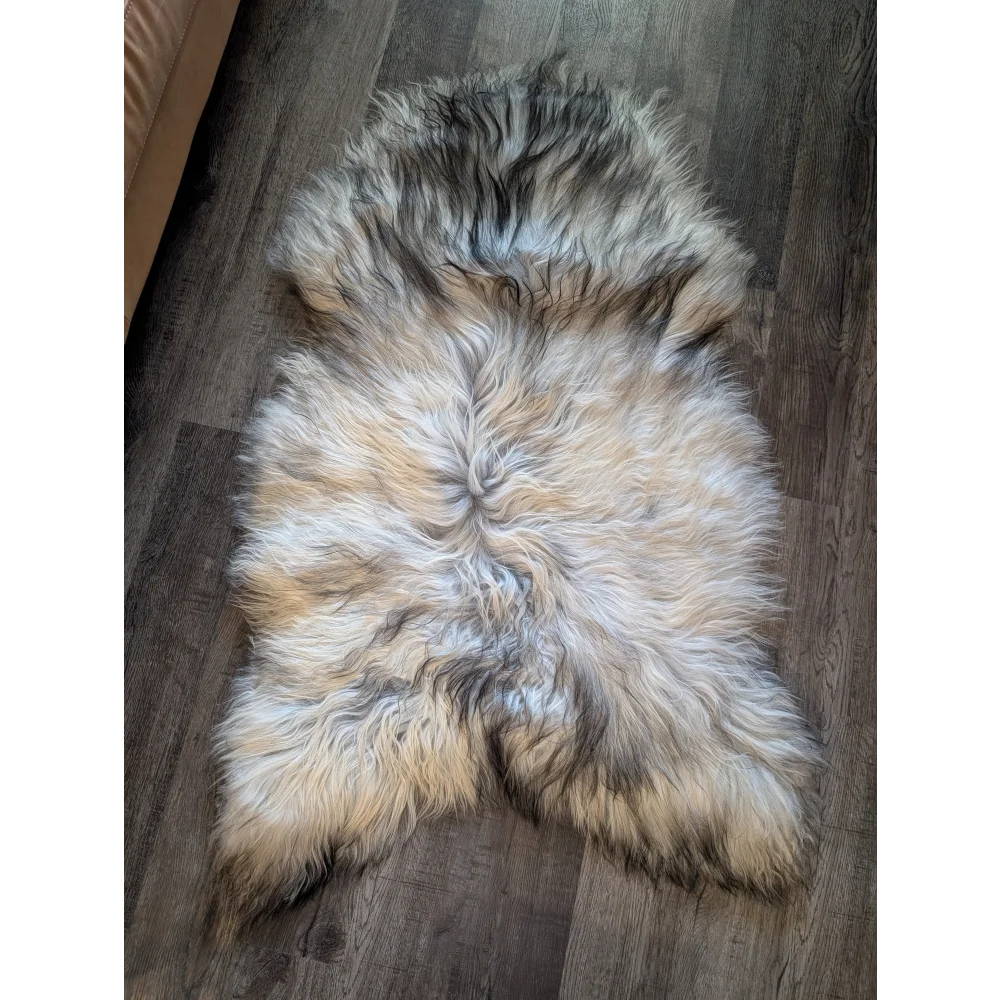 A plush massive icelandic sheepskin rug with double icelandic wool in natural grey cream beige and dark gray tones