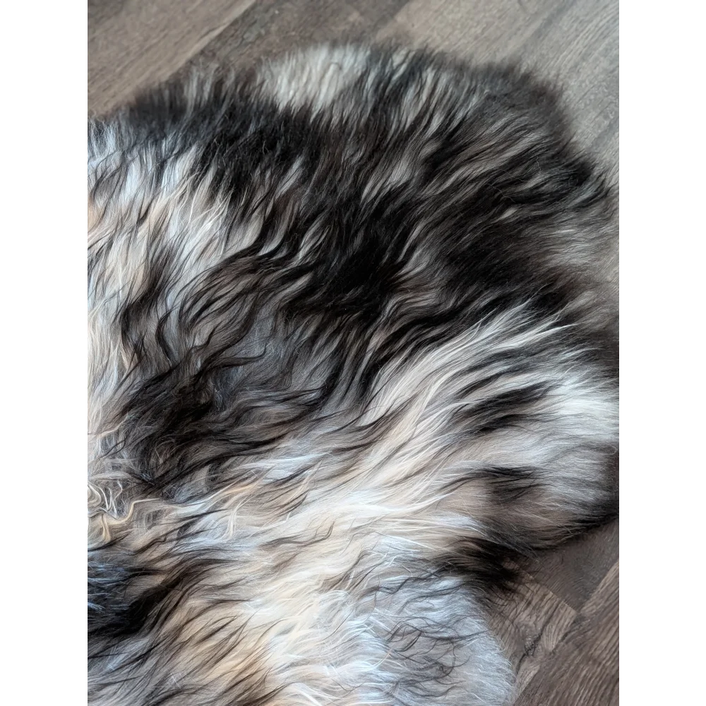 A plush double icelandic sheepskin rug with natural grey wool icelandic fur in black white and gray blend
