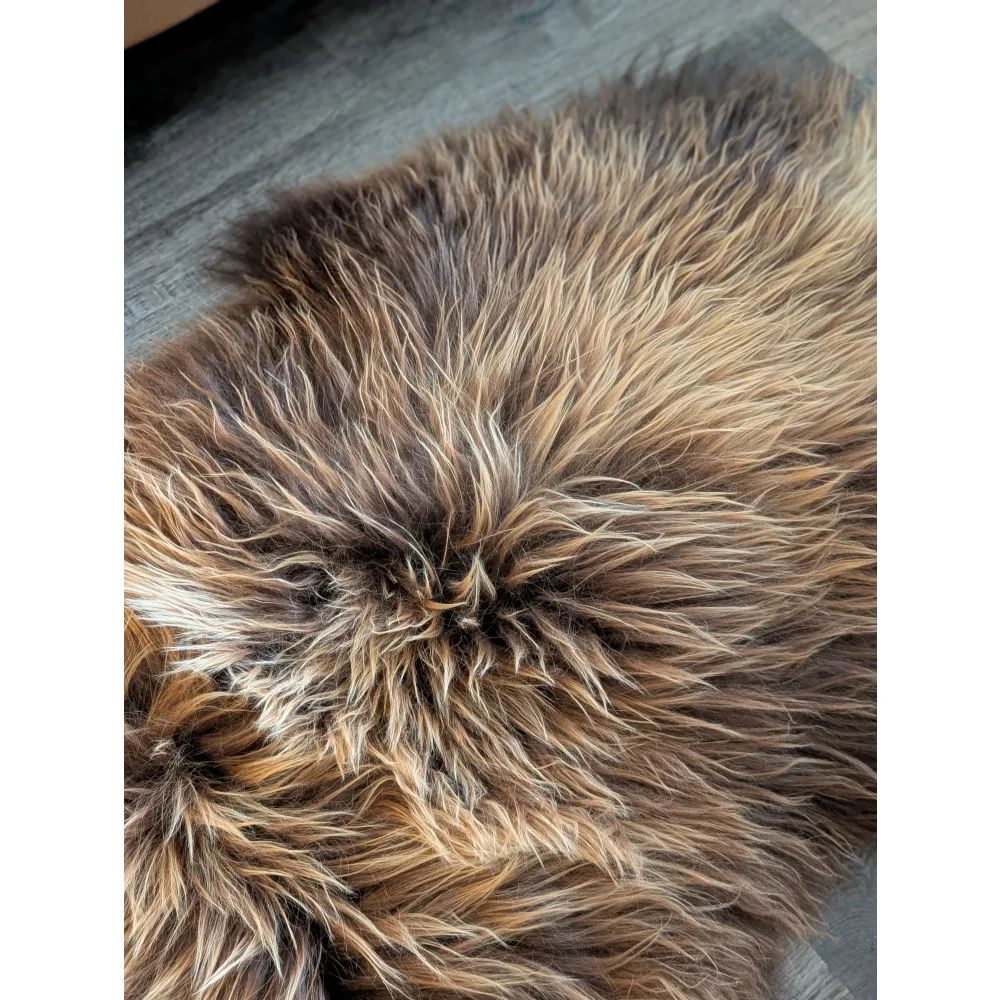 A plush 56 x 32 inch icelandic sheepskin rug with long wool icelandic texture in natural bronze tones