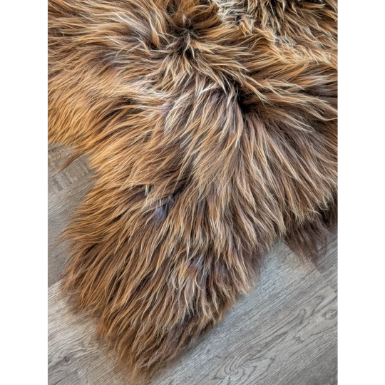 A plush long wool icelandic sheepskin rug in natural bronze color with soft texture measuring 56 by 32 inches