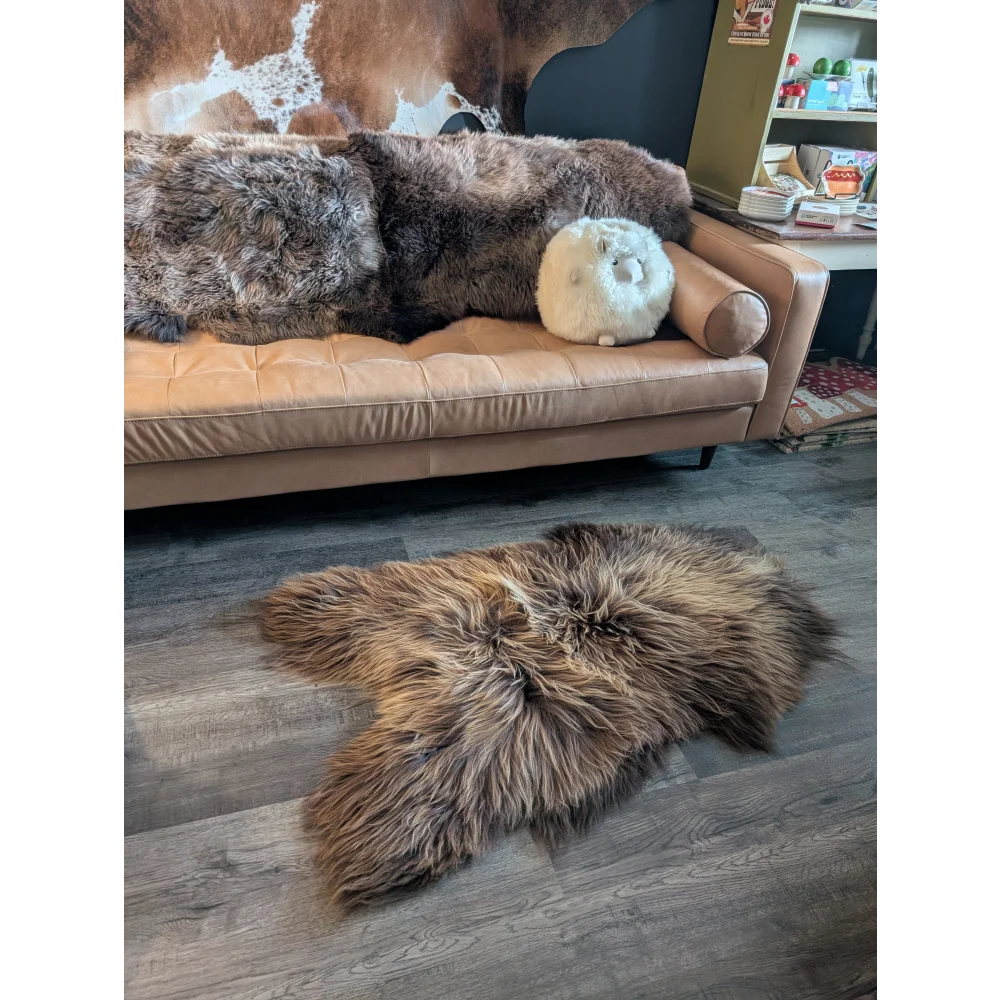 Brown fluffy icelandic sheepskin rug with long wool icelandic texture in natural bronze color and irregular shape
