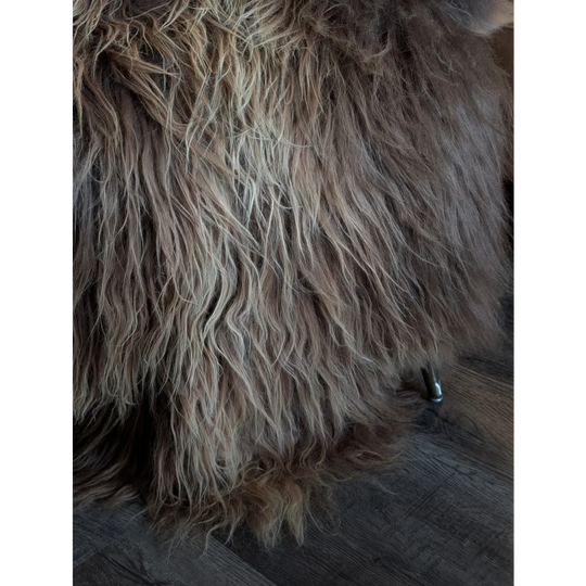 A plush 61 x 38 inch icelandic sheepskin throw blanket in natural bronze with long wool icelandic shaggy texture