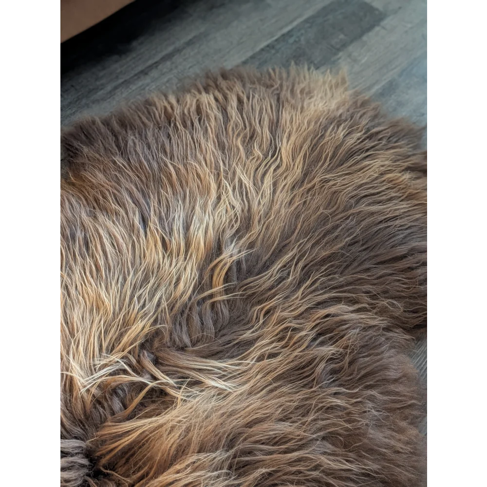 A plush shaggy brown and beige faux fur rug with soft wool icelandic texture in natural bronze color 61 by 38 inches