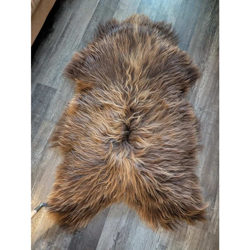 A plush brown icelandic sheepskin rug 60x36 with long wool icelandic fur in natural bronze shades