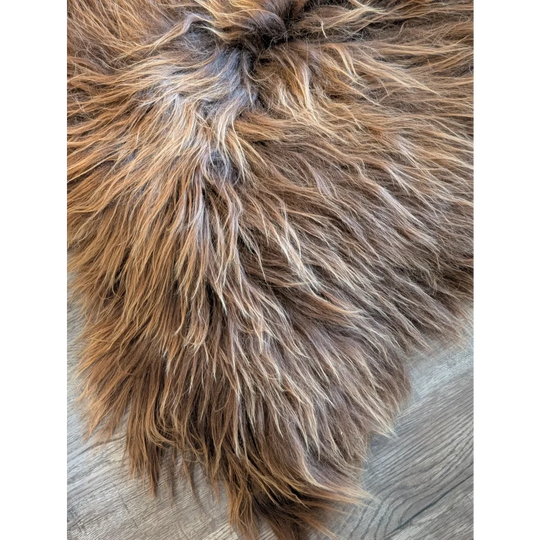 A plush long wool icelandic faux fur rug in brown and tan with soft shaggy texture sized 60 by 36 inches