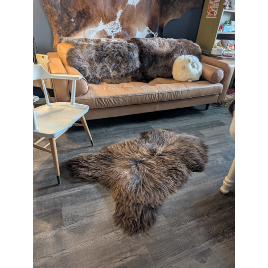 Brown fluffy natural bronze icelandic sheepskin rug with long wool icelandic soft texture and irregular shape