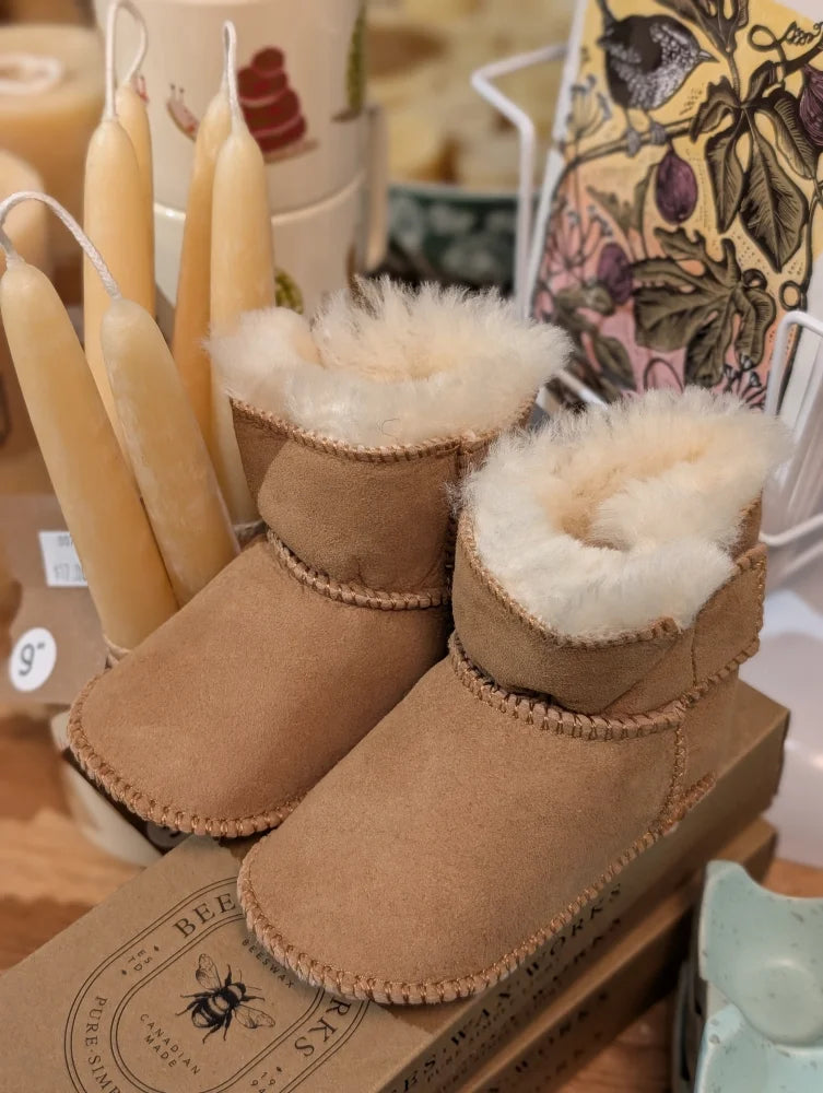 Cute tan UGG sheepskin baby booties with fur lining, ten pairs