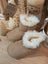 Tan suede sheepskin baby booties with white fur trim and gold chain
