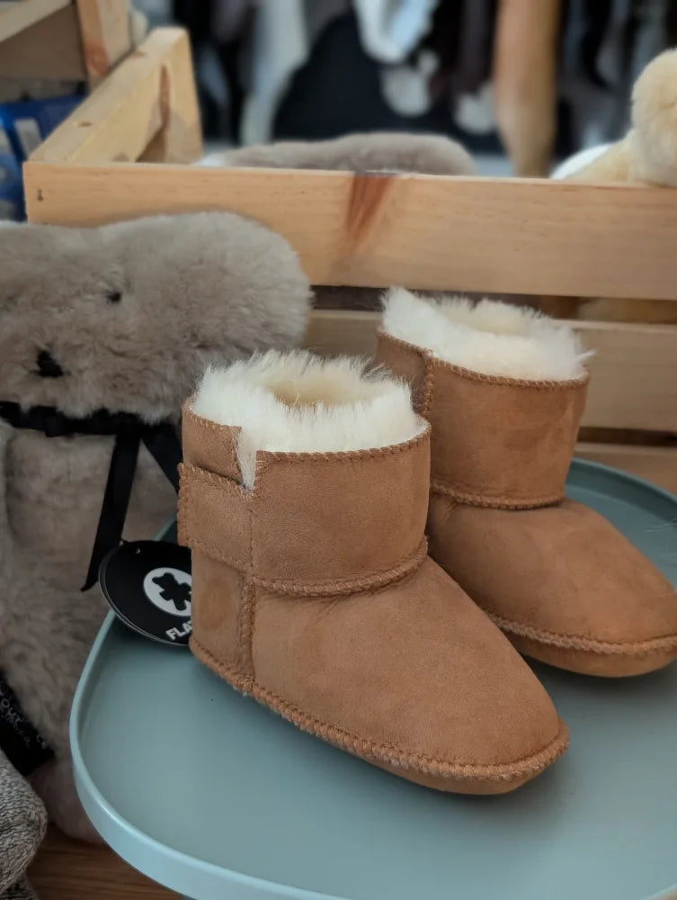 Tan sheepskin baby booties with shearling lining and star design
