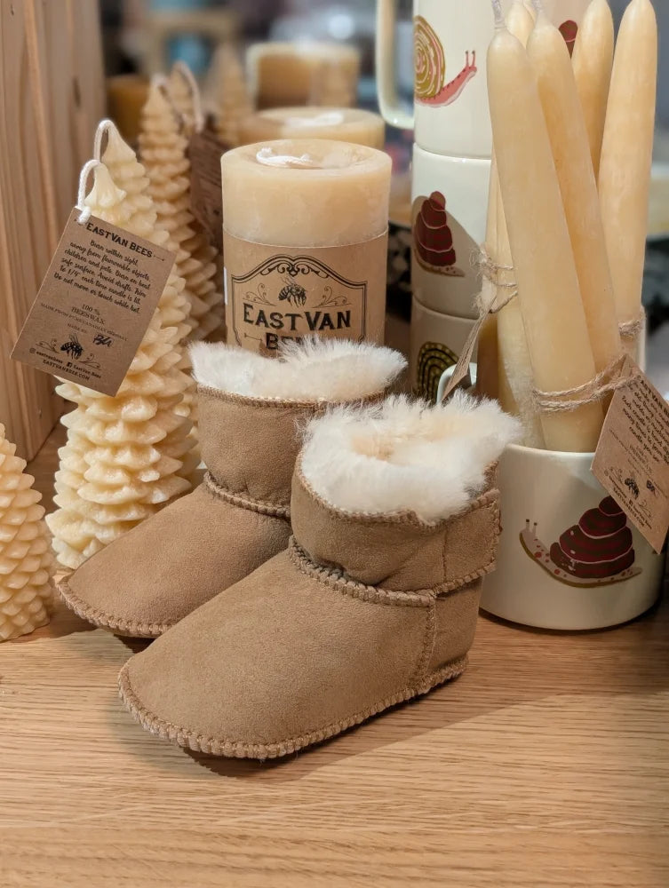 Tan sheepskin baby booties with white fur lining