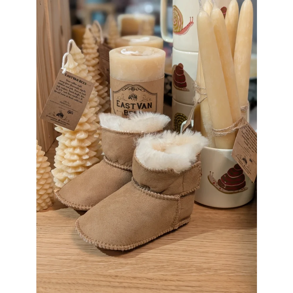 Tan sheepskin baby booties with white fur lining