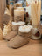 Tan sheepskin baby booties with white fur lining