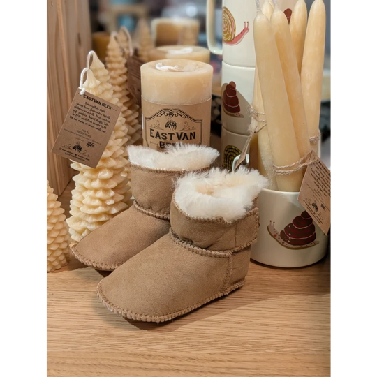 Tan sheepskin baby booties with white fur lining