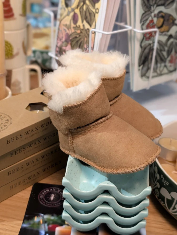 Tan sheepskin baby booties with fur lining and wave soles