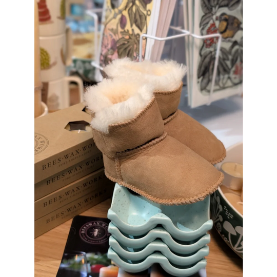Tan sheepskin baby booties with fur lining and wave soles
