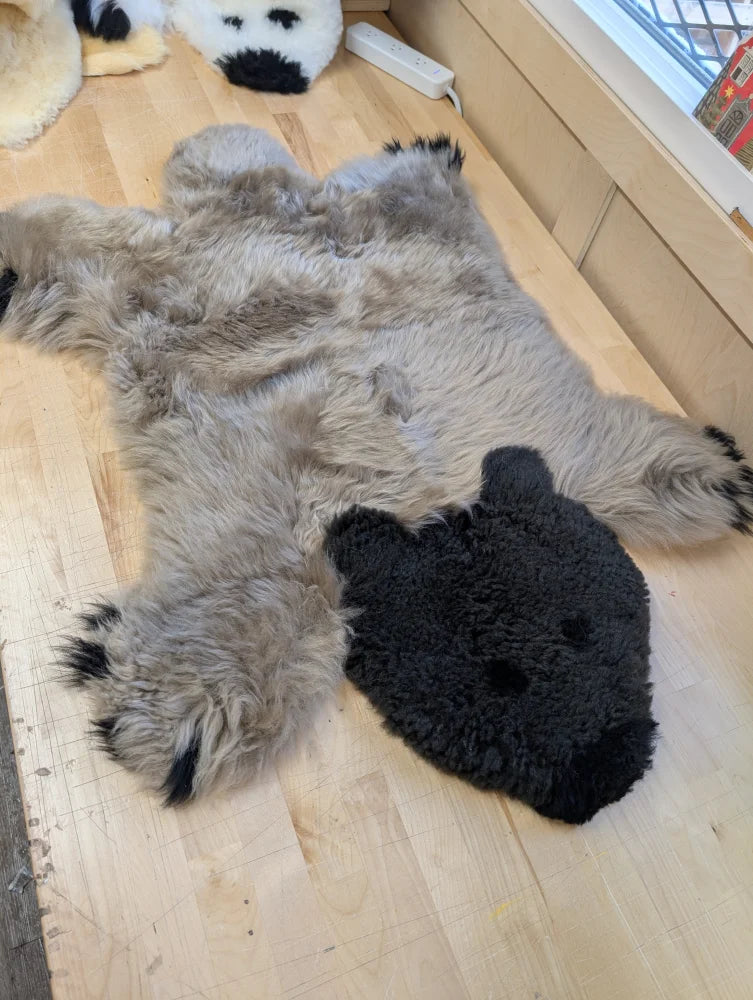 Gray faux fur sheepskin bear rug with black plush head and paw tips hand made for cozy decor like a grizzly bear rug