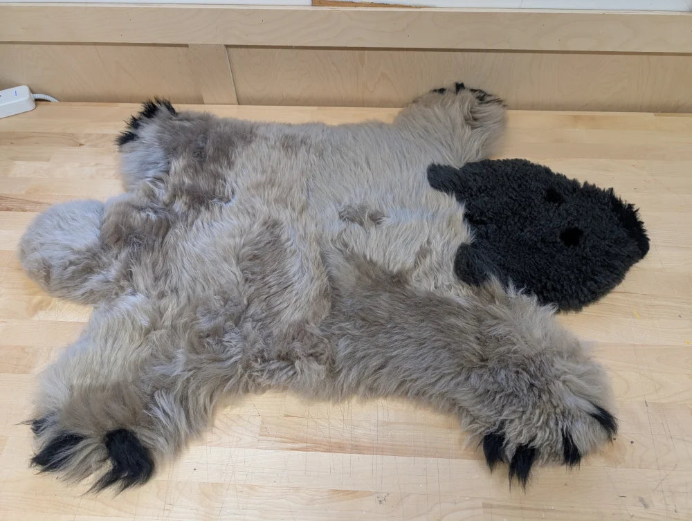 Gray and black hand made sheepskin bear rug with fluffy merino sheepskin texture perfect as a grizzly bear rug