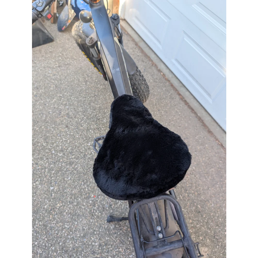 Black fuzzy merino sheepskin bicycle seat cover with elastic edges