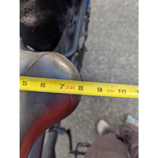 Yellow tape measure on merino sheepskin bicycle seat cover