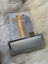 Silver sheepskin brush with gold handle and black bristles by Peb Tools