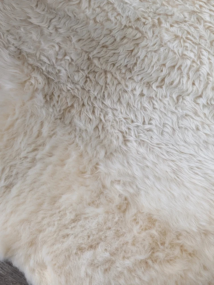 Cream faux fur throw with fluffy texture in Sheepskin Care Pack