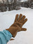 Brown suede glove with visible stitching along the fingers and back.