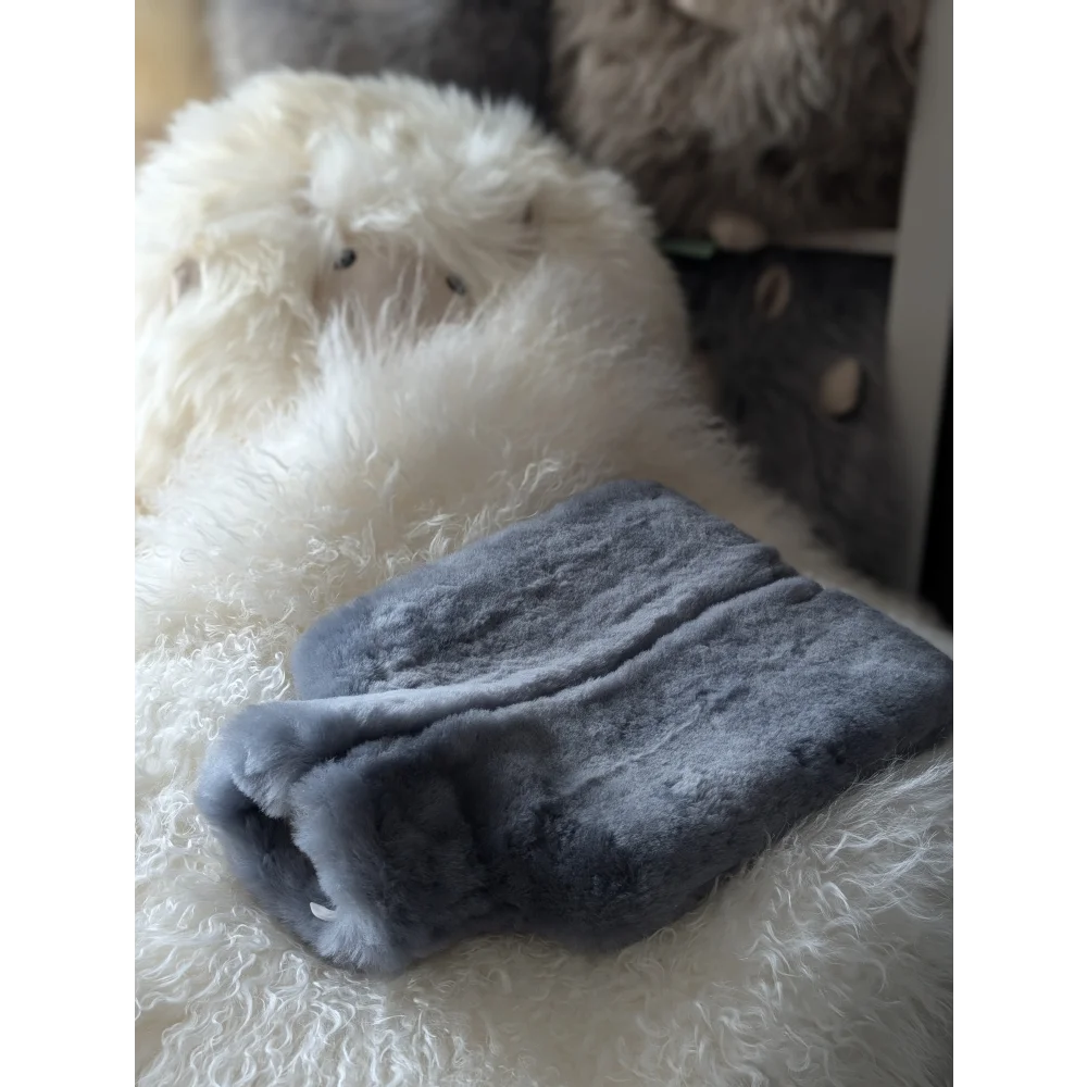 Gray sheepskin hot water bottle cover with plush fleece for chilly nights