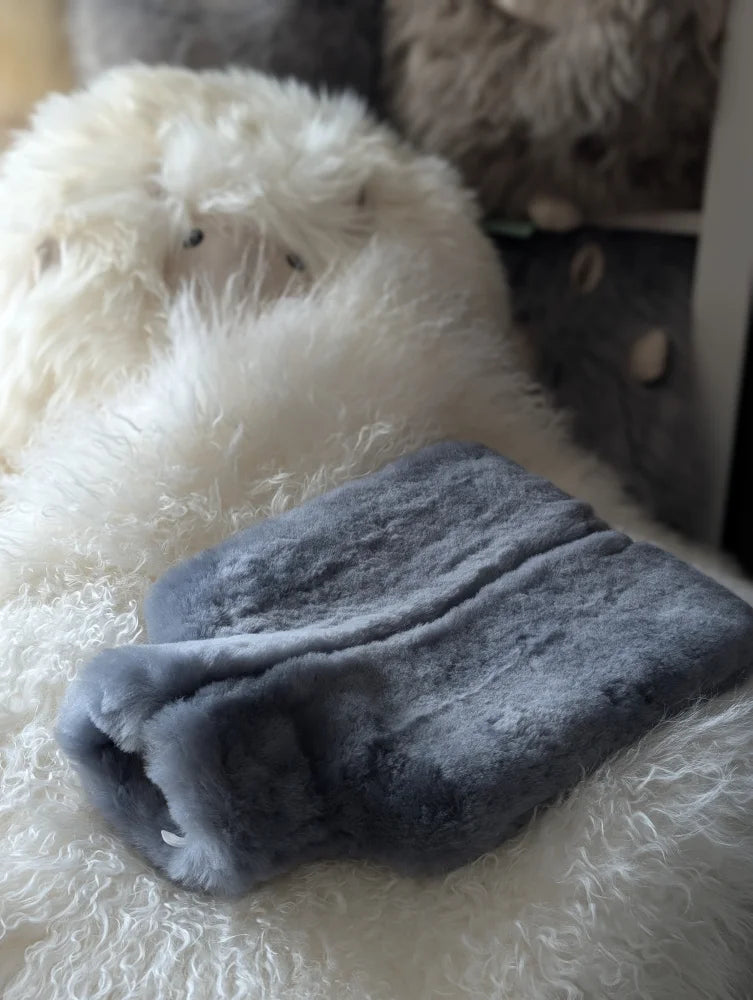 Gray sheepskin hot water bottle cover with plush fleece for chilly nights