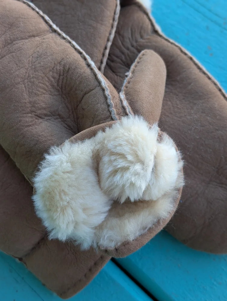 Brown sheepskin mittens with plush white fur lining and matching stitching perfect for winter mittens and sheepskin gloves
