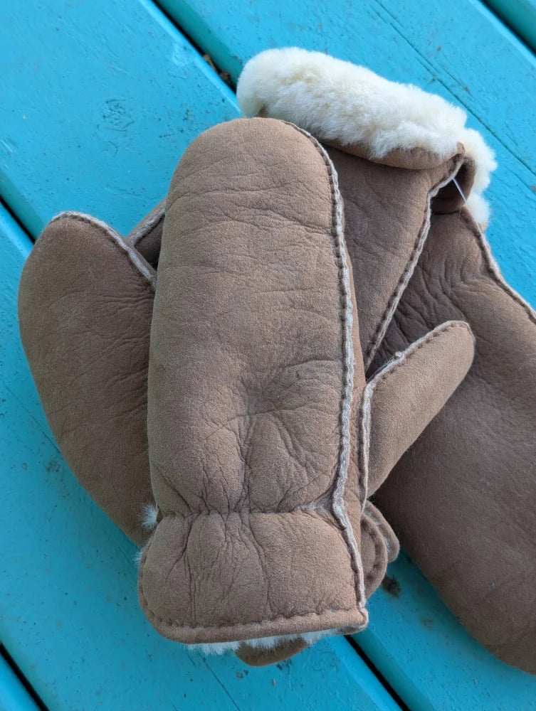 Tan sheepskin mittens with plush white fleece lining perfect for cozy winter mittens or sheepskin gloves use