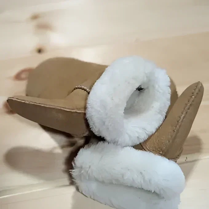 Tan leather UGG boot with white fur lining, like sheepskin mittens