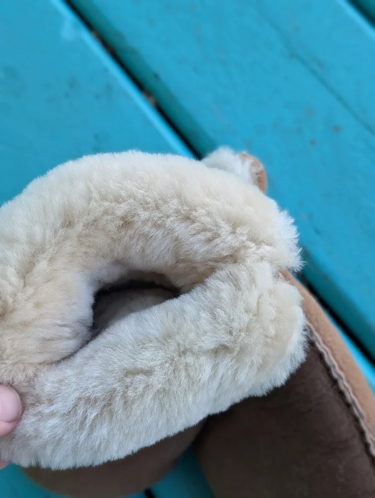 Cream-colored slip-on boot with tan leather and shearling lining perfect for winter mittens and sheepskin gloves users
