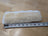 White fluffy sheepskin noseband cover with black tape measure
