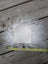 White fluffy sheepskin sample square with a square cutout showing soft wool texture and natural leather backing