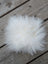 A fluffy white sheepskin pom pom from sheepskin sample squares perfect for soft cozy accents