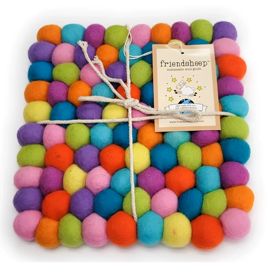 A colorful square eco coaster made of tightly packed wool balls in vibrant rainbow hues perfect as an eco trivet