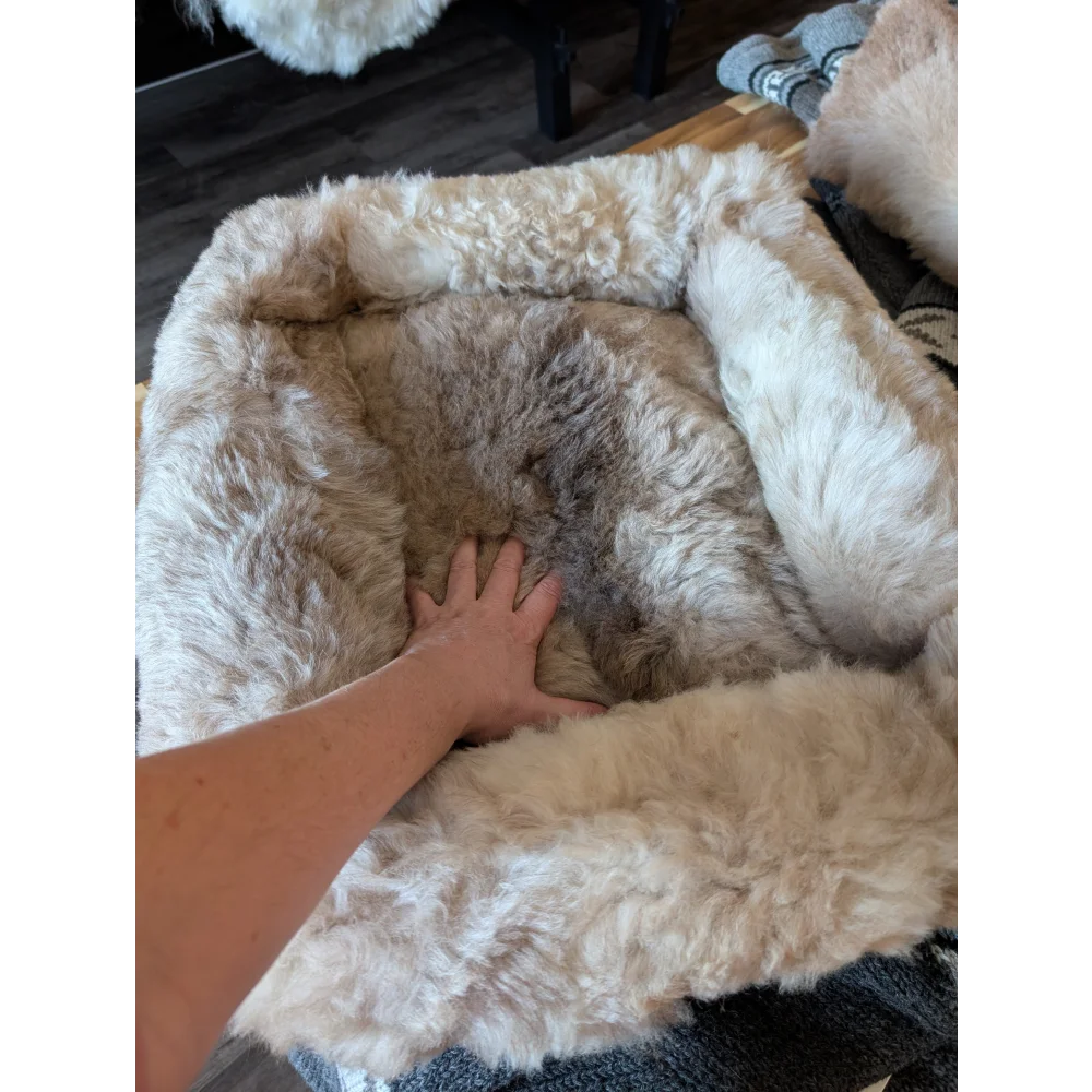 Cozy beige and brown highland sheepskin pet bed with plush faux fur interior