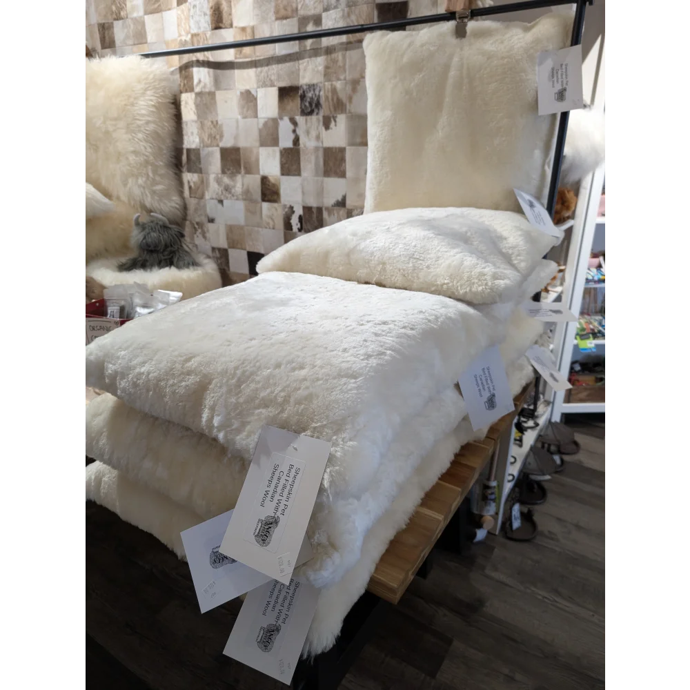 Cozy cream merino sheepskin pet bed stuffed with Canadian sheep’s wool
