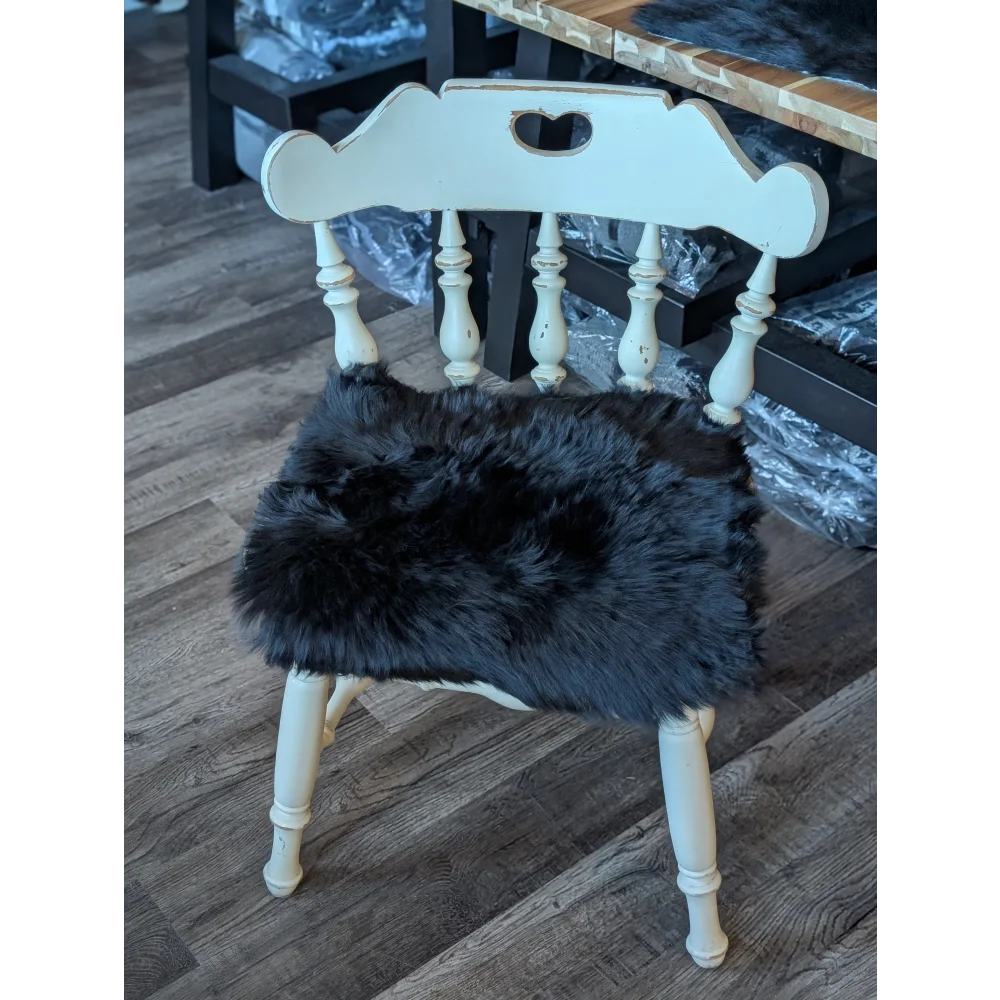 White wooden spindle back chair with gorgeous black merino sheepskin pad