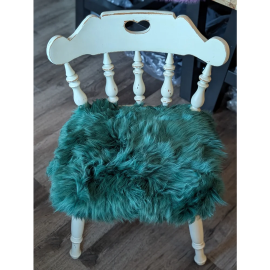 Teal faux fur sheepskin chair pad in gorgeous green merino on white wooden frame