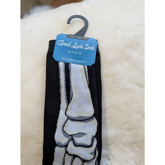 Black and gray skeleton foot good luck socks with active fit label