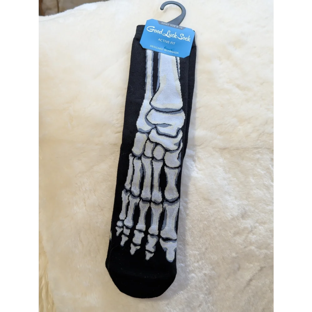 Black and white skeleton foot good luck socks on hanger