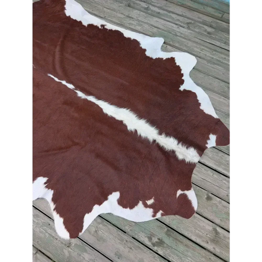 Large 85’’ x 74.5’’ cowhide rug with brown white patches and leather texture