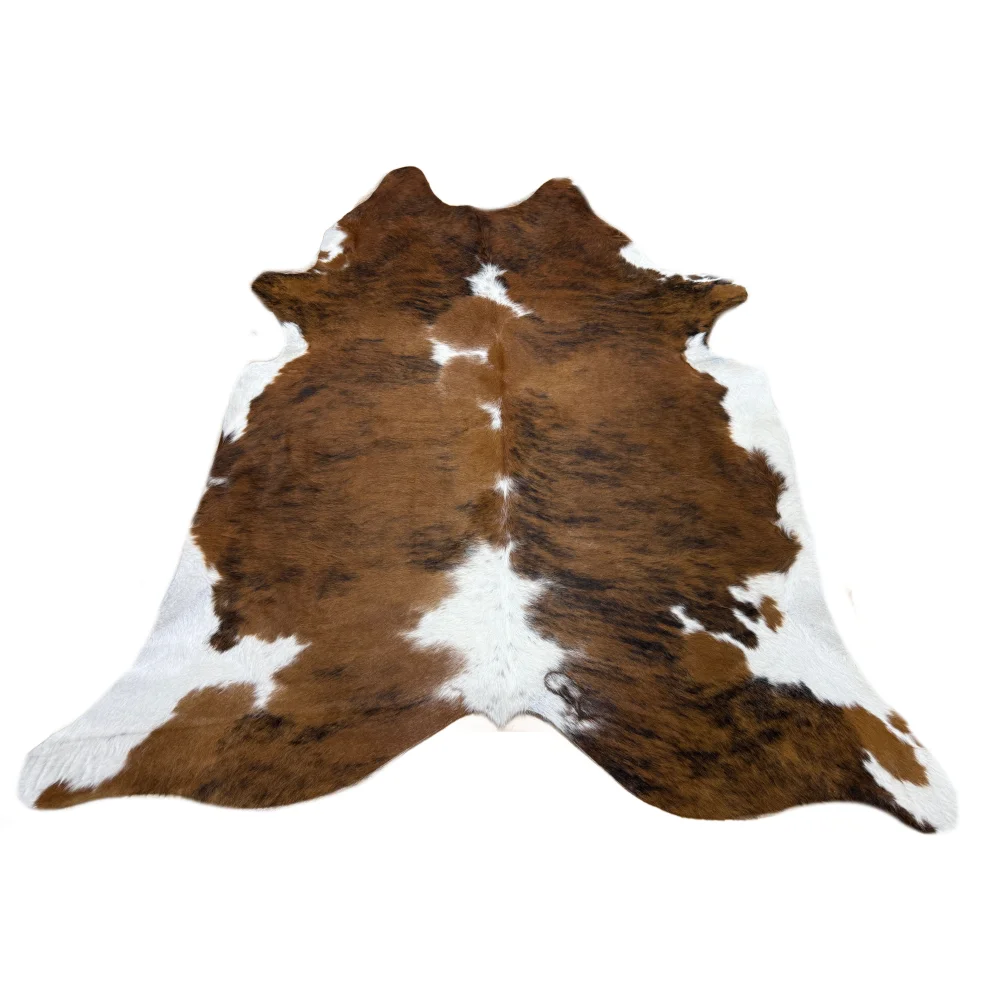 Soft underfoot brown and white cowhide rug with natural fur texture