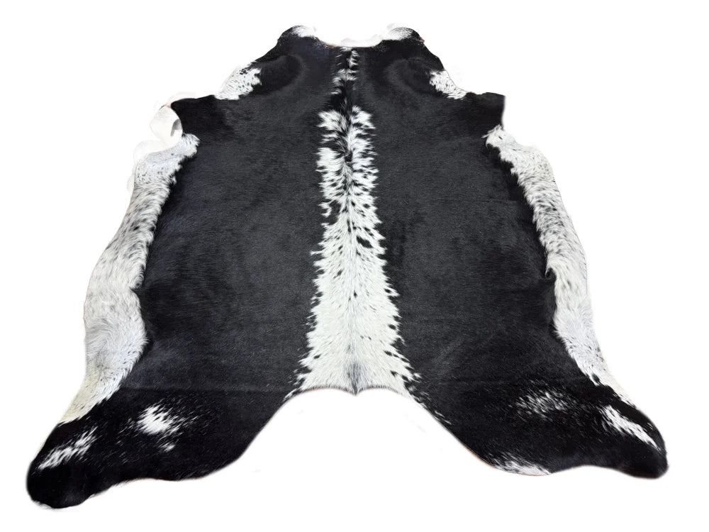 Small black and white cowhide rug with soft underfoot natural fur texture