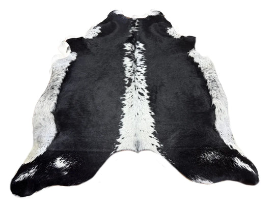 Small black and white cowhide rug with soft underfoot natural fur texture