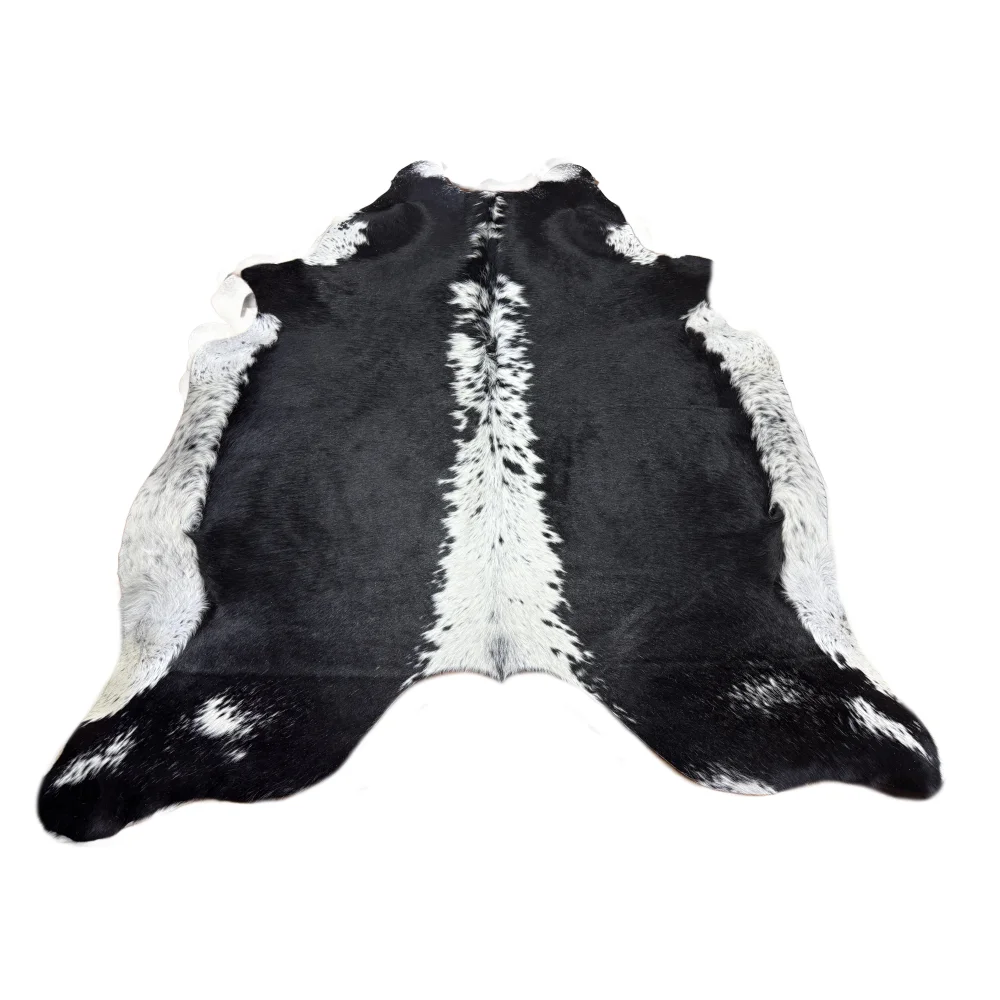 Small black and white cowhide rug with soft underfoot natural fur texture