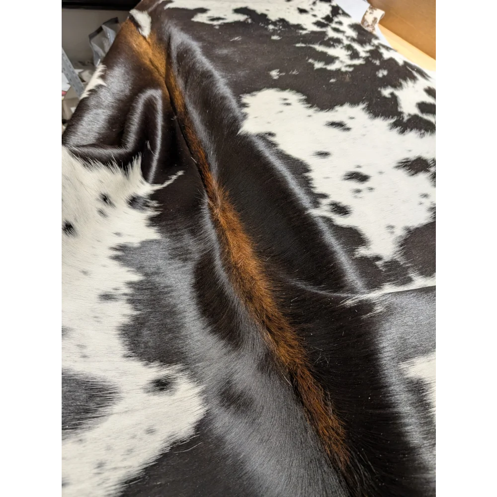 Large cowhide rug with unique brown fur edges, 85.5x72 inches