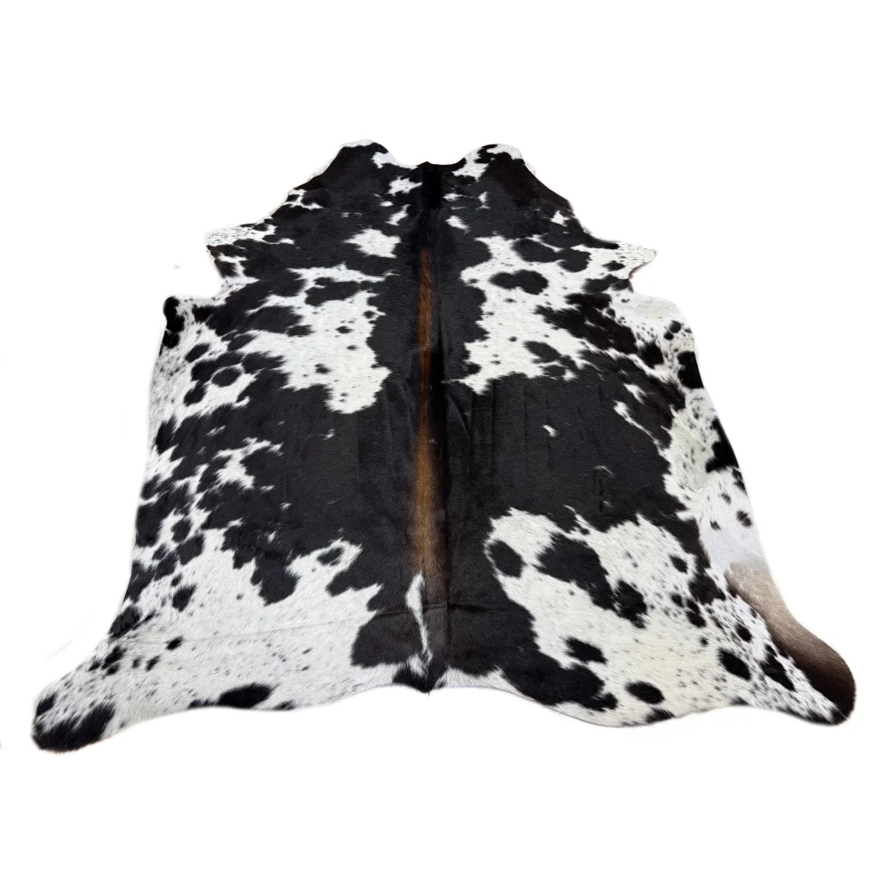 Black and white spotted cowhide rug with unique characteristics