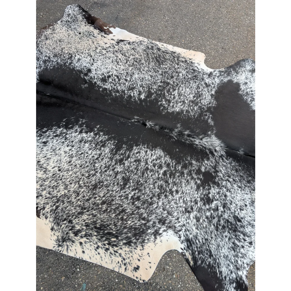 Black and white speckled large cowhide rug with textured surface for stylish home decor